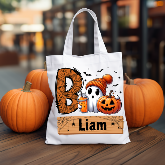 Personalized "Boo! Cute Ghost with Iced Coffee" trick-or-treat tote bag featuring a whimsical ghost design, perfect for collecting candy during Halloween festivities.