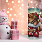 Holiday-themed tumbler with a cute Highland cow wearing a plaid bow, nestled in a stocking, surrounded by gifts, Christmas ornaments, and festive greenery.