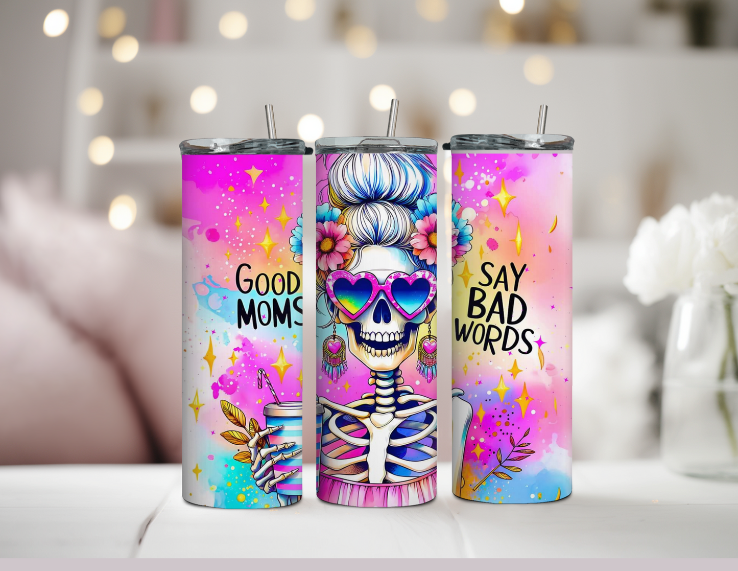 20oz Skinny Tumbler featuring a colorful skeleton with a messy bun, heart-shaped retro sunglasses, and an iced coffee in hand. Bright pink and purple background with the text 'Good Moms Say Bad Words.' Stainless steel tumbler with double-wall vacuum insulation, perfect for keeping drinks hot or cold. Ideal for moms with bold, playful personalities and love for retro vibes.