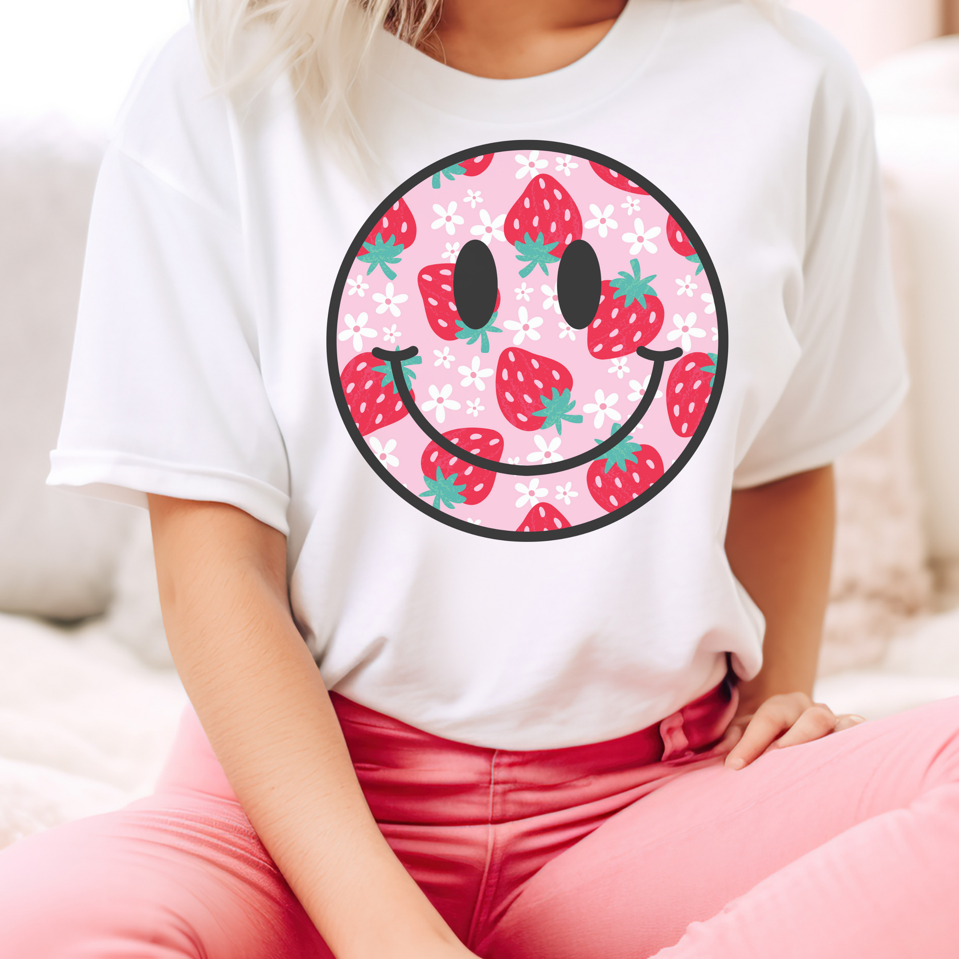 Pink background shirt featuring a strawberry and daisy smiley face design for a playful, cheerful look. Unisex fit, perfect for casual days