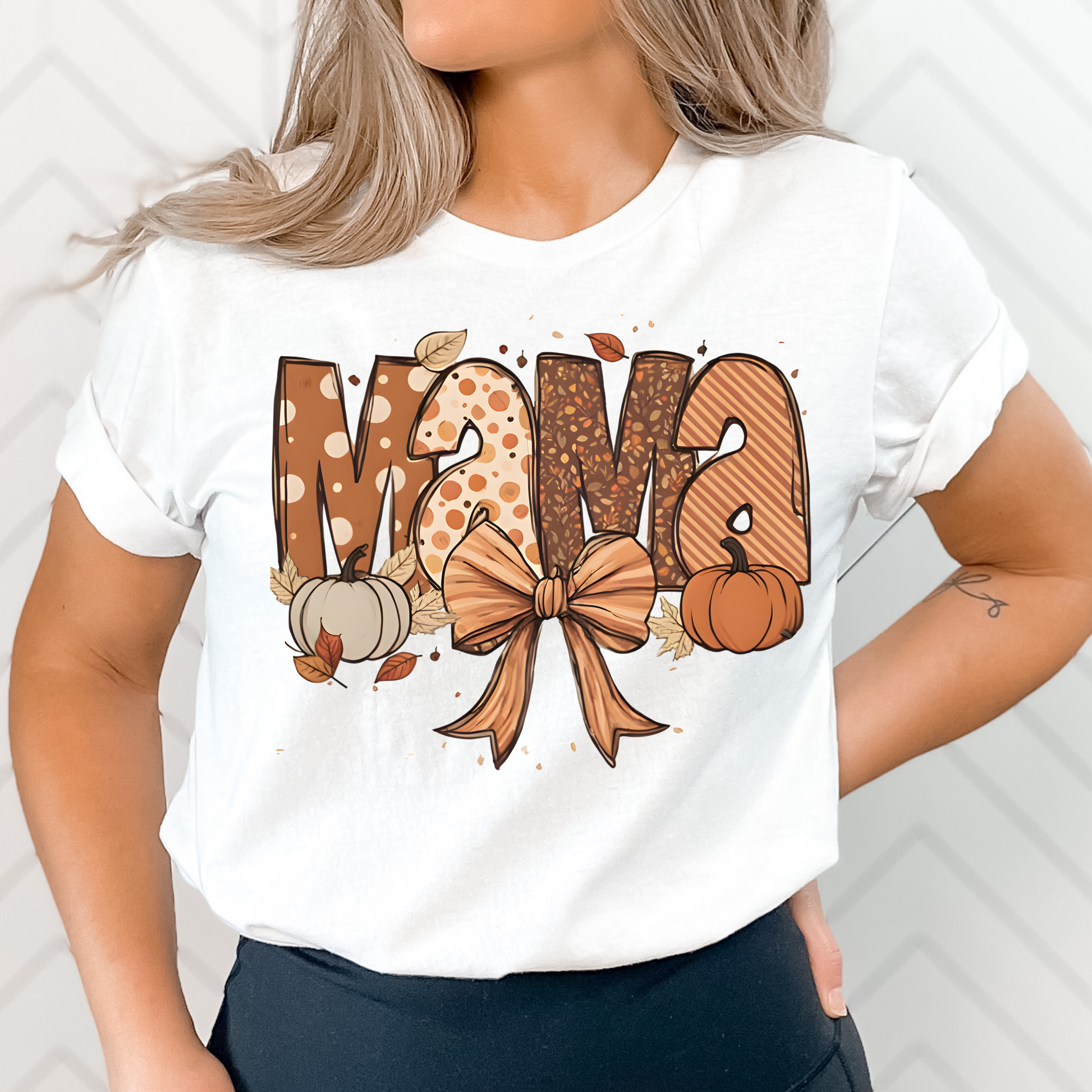 Fall Mama Shirt in soft pink featuring cute pumpkins, fall leaves, and a stylish bow design. Perfect graphic tee for autumn-loving moms.