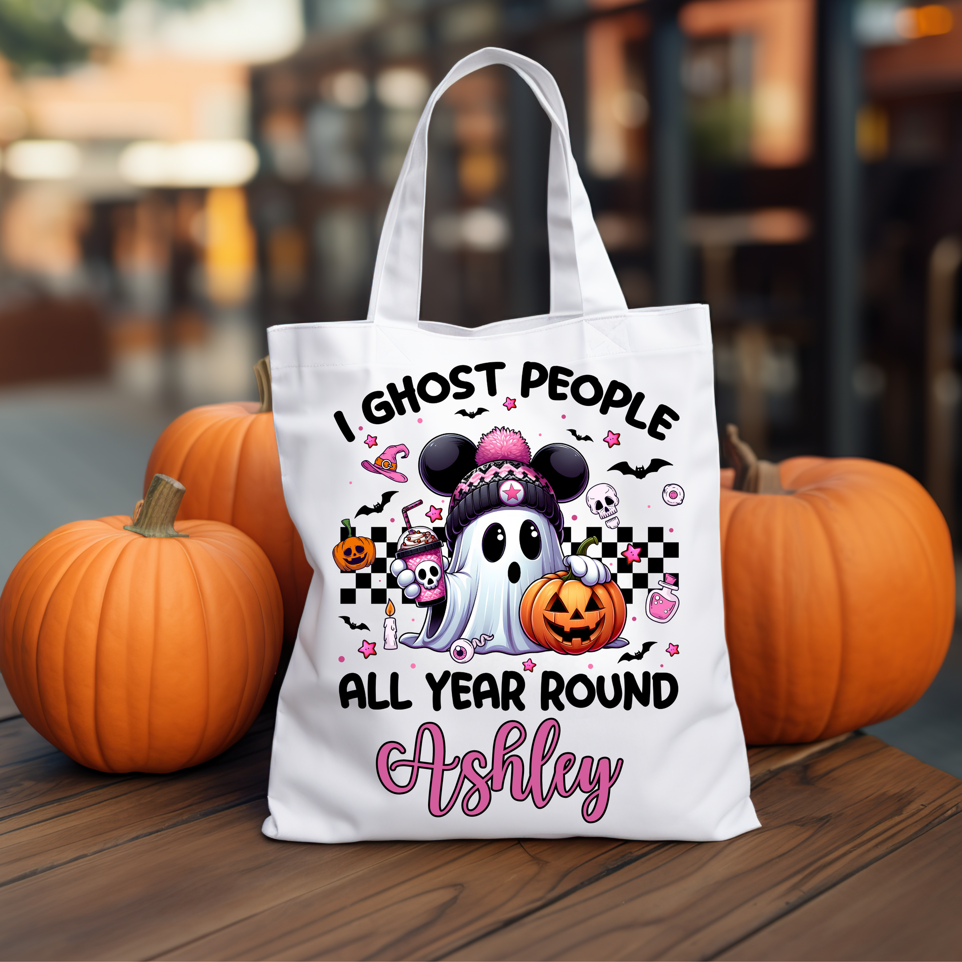 Cute ghost with mouse ears trick-or-treat bag featuring the phrase "I Ghost People All Year Round," perfect for Halloween candy collection and festive outings.