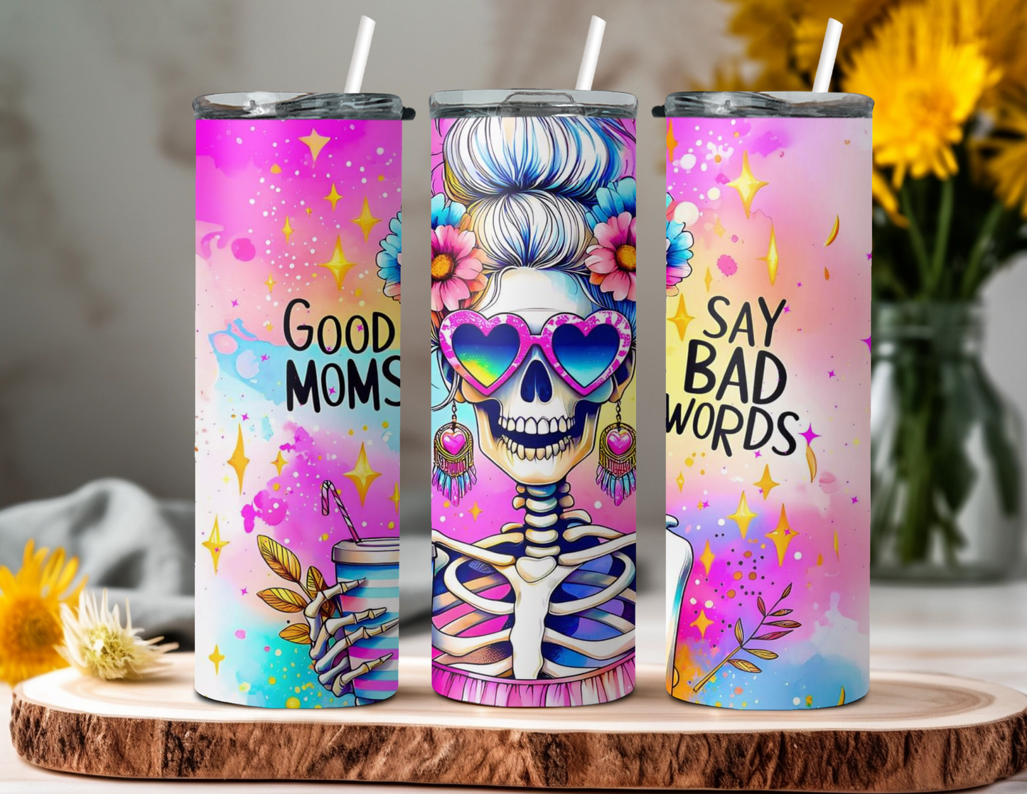 20oz Skinny Tumbler featuring a colorful skeleton with a messy bun, heart-shaped retro sunglasses, and an iced coffee in hand. Bright pink and purple background with the text 'Good Moms Say Bad Words.' Stainless steel tumbler with double-wall vacuum insulation, perfect for keeping drinks hot or cold. Ideal for moms with bold, playful personalities and love for retro vibes.