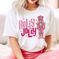 Woman wearing a Christmas shirt with pink "Holly Jolly" text and nutcracker design.