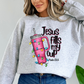 Light pink sweatshirt featuring a tumbler wrapped in Christmas lights with the text “Jesus Fills My Cup” and Psalm 23:5