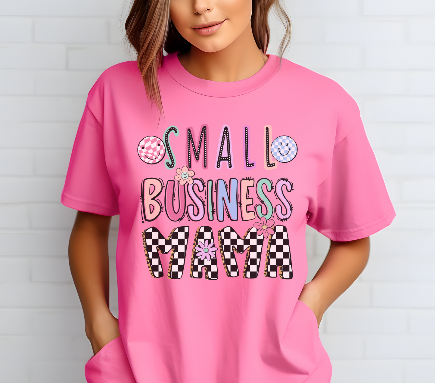 Small Business Mama Retro Daisy Unisex Shirt. Features a retro daisy graphic with the text 'Small Business Mama,' celebrating entrepreneurial pride. Soft cotton material in a unisex fit, available in various colors. Ideal for casual wear, business events, and as a gift for mompreneurs. Machine washable for easy care.