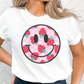 Pink background shirt featuring a strawberry and daisy smiley face design for a playful, cheerful look. Unisex fit, perfect for casual days