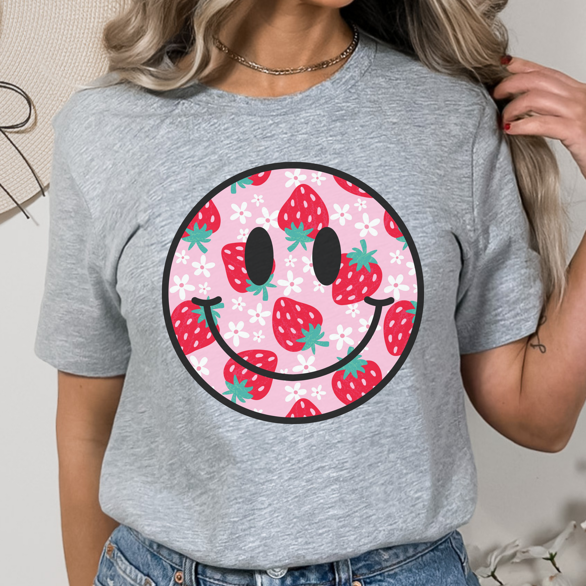 Pink background shirt featuring a strawberry and daisy smiley face design for a playful, cheerful look. Unisex fit, perfect for casual days